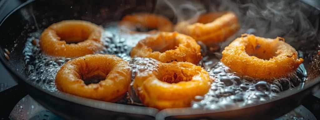 golden donuts sizzling in a skillet, perfectly shaped and perfectly fried.